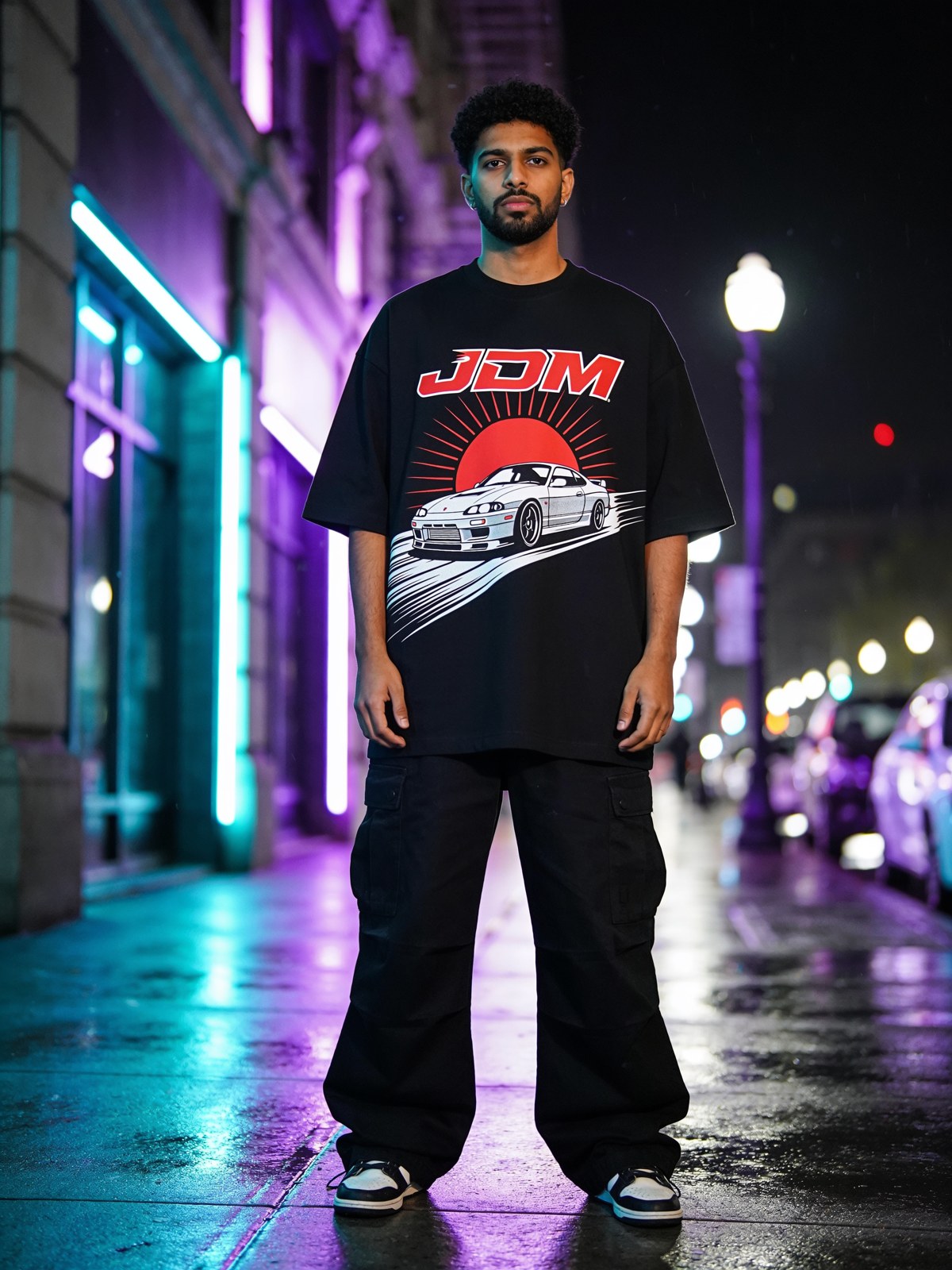 Model wearing a JDM sports-coupe graphic on a neon street — Gran Turismo collection