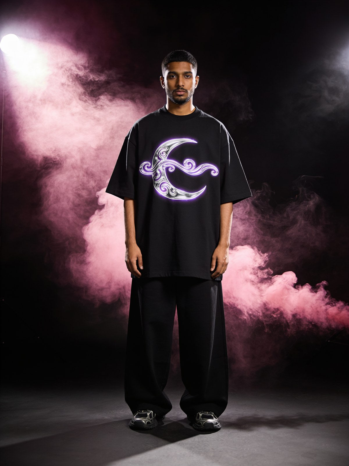 Model wearing a crescent-moon streetwear graphic — New Drops collection